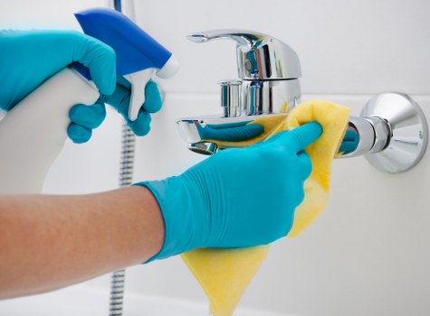 Janitorial staff performing commercial cleaning in a workplace hallway